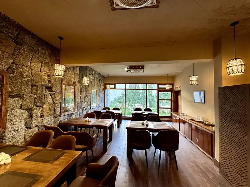 Restaurant tables beneath pendant lanterns