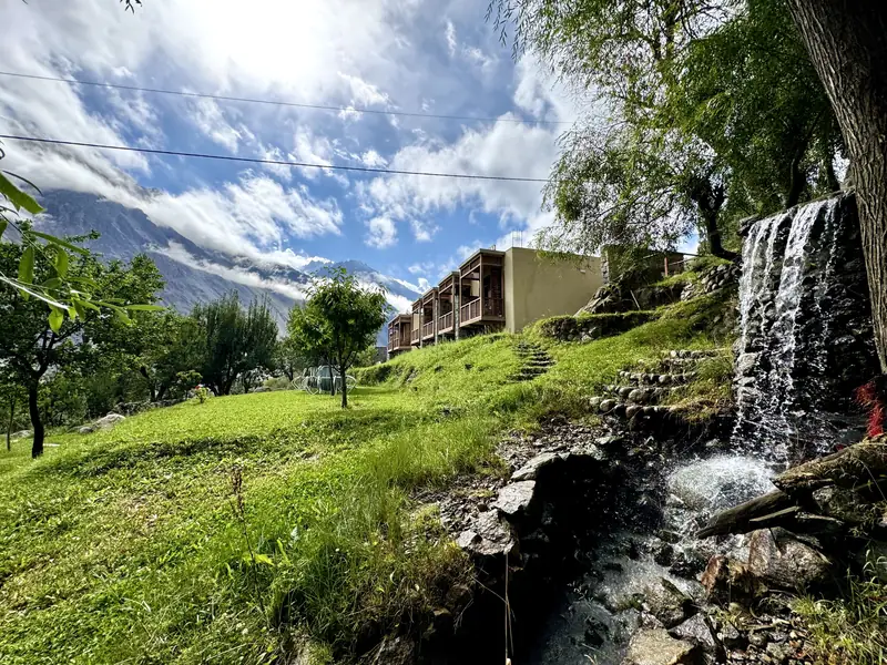 The garden waterfall tumbling past the resort's timber balconies